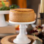 Pumpkin spice cheesecake on cake stand.